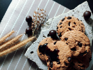 Chocolate chip cookies on rocks and elements Has a black background