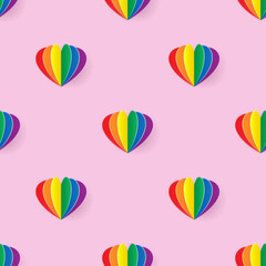 Seamless pattern with rainbow heart paper art style on light pink background
