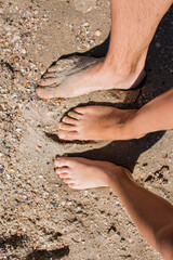 people feet in the sand on the beach