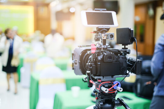 Camera Set Up On Tripod Recording Presentation Performance, Vlog Filming Video On Activities Within Hall Room Indoor With Video Filming And Sound Attachment Tools And Equipment, Blur Bright Background