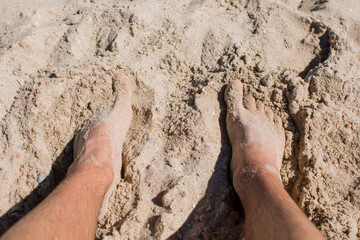 people feet in the sand on the beach