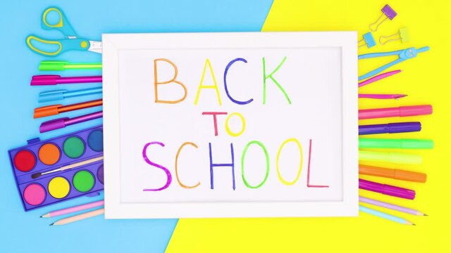 Back to school stationery moving under white frame with back to school title. Stop motion 