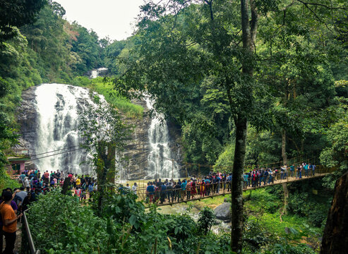 View of Abbey Falls with people flocking the hanging bridge.