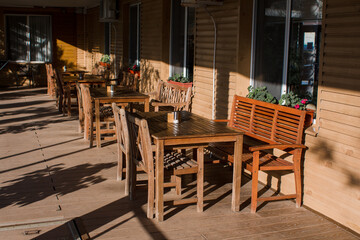 Fototapeta na wymiar wooden tables in a restaurant on the street
