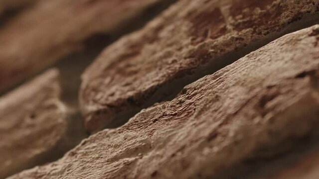 Slow motion closeup man hand touching old brick wall