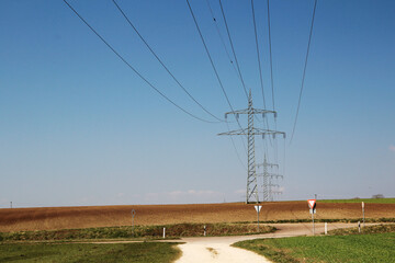 Electricity cable lines against bright blue sky