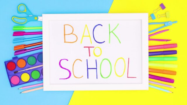 School stationery appear under white frame with back to school title. Stop motion 