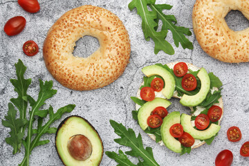 Sesame bagels with tomatoes and avocado
