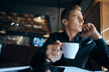 Business man freelancer working in a cafe laptops communication phone room manager model
