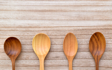 Top view, Four blank wooden spoons on the wooden floor.
