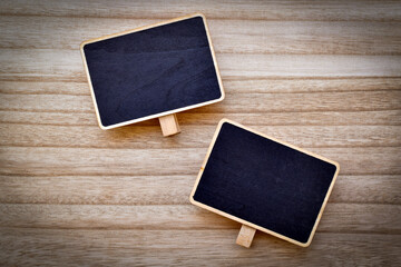 Top view, Two small pieces of blackboard on wooden table.