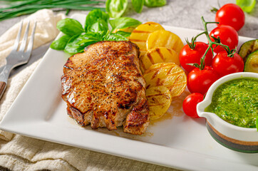 Delicious pork steak with herbs sauce