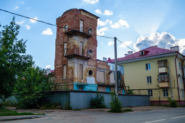 Remains of old soviet fire tower with unusial round windows. Building is fenced as it repairs. Shot in Kazan, Russia