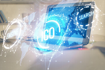 Multi exposure of blockchain theme hologram and table with computer background. Concept of bitcoin crypto currency.