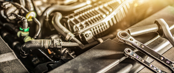 Auto mechanic working and repair on car engine in mechanics garage. Car service.