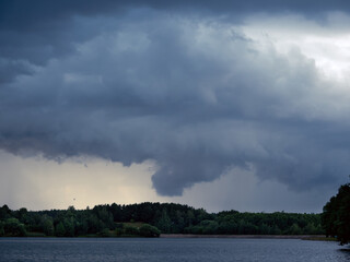 Dark thunderclouds on a gray sky. Weather forecast. Thunderstorm and storm.