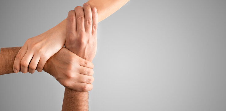 Top view of holding hands. Concept of unity, teamwork and support.