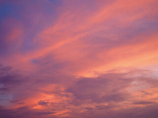 Bright sky illuminated by pink sunset light as background and texture.