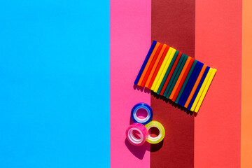 Colored background seen from above with plastic bars to use in crafts and stationery.