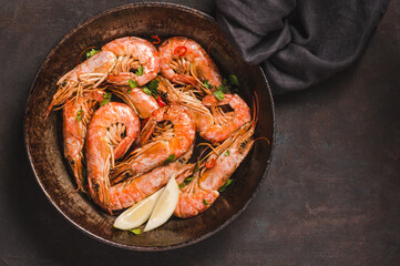 Shrimps delicious dish on dark background copy space.