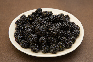 blackberries on a white plate