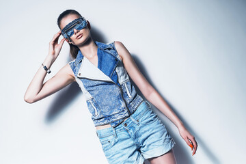 woman in sunglasses and denim waistcoat