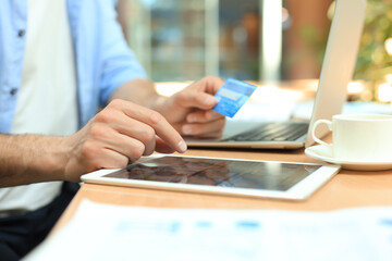 Young modern business man working using digital tablet while sitting in the office.
