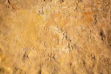 brown grainy cement wall background with curious abstract shapes