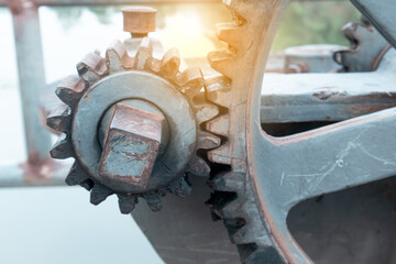 Close up large gears of the floodgate are mounted on an outdoor concrete base, used to control the opening and closing of the floodgate of a dam, reservoir or large waterway.