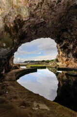 Fototapeta na wymiar Grotta Di Sperlonga - A huge cave with the remains of a pool and a fountain from the grotto offers a magnificent view of the village of Sperlonga. Italy