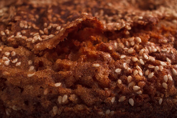 Closeup of a homemade sponge cake with cinnamon and sesame.