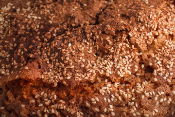 Closeup of a homemade sponge cake with cinnamon and sesame.