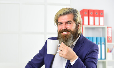 Breakfast tea. Morning beverage. Businessman drink coffee in office. Enjoyment. Tea time. You have to trust your instincts. Relax and keep calm. Drink coffee. Bearded man drinking hot beverage
