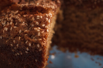 Closeup of a homemade sponge cake with cinnamon and sesame.