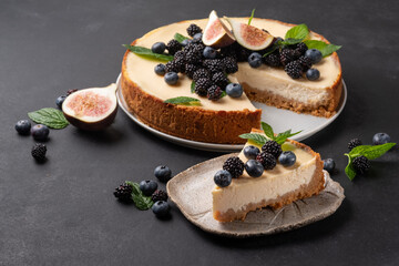 Cheesecake slice, New York style classical cheese cake on black background. Slice of tasty cake on white plate 