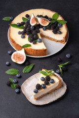 Cheesecake slice, New York style classical cheese cake on black background. Slice of tasty cake on white plate 