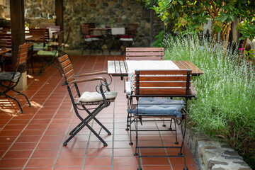 Close up view of outdoor tables of restaurant waiting for customers.