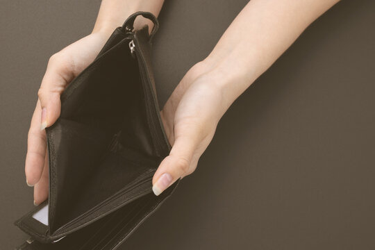 The financial crisis due to the coronavirus pandemic. Empty wallet without money in female hands