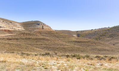 landscape of a semi-arid steppe between Caltojar and Bordecorex and an islamic watchtower, province of Soria, Castilla y Leon, Spain