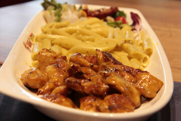 Chicken, rice and salad on a serving plate