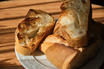 Roasted bread slices on wooden table