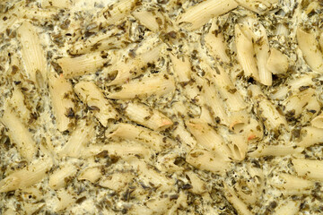 Pasta with spinach, cheese and eggs baked in the oven. Close-up. Top view. 