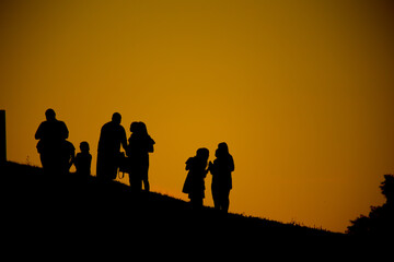 Fototapeta na wymiar Silhouette of a group of people against the sky