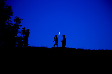 Fototapeta premium Silhouette of a group of people against the sky