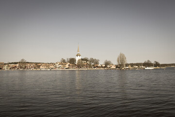 Fototapeta na wymiar Swedish town Mariefred by lake Malaren, Sweden. Aged photo effect.