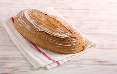 Homemade whole wheat bread in kitchen towel