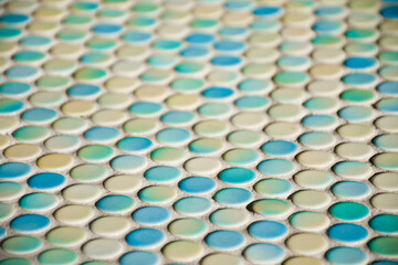 Close up of blurred round colorful tiles - yellow, tourquise and blue. Abstract background