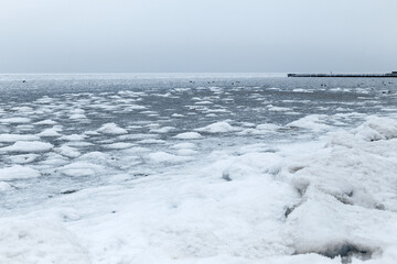 Sea covered with broken ice. Front focus. Black sea in winter