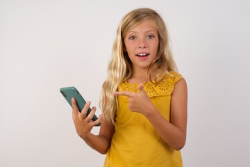 Portrait of Little girl with beautiful blonde hair over white background holding in hands showing new cell,