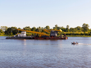 Kasimov, Russia - July 24, 2015: Barge goes along Oka River near town of Kasimov on summer day.